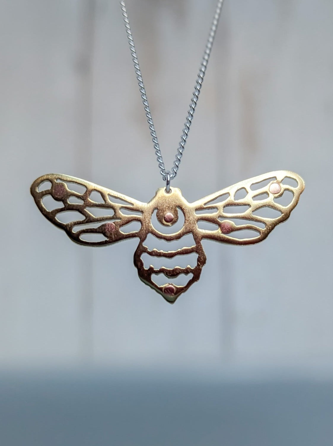 Geometric cut out bumblebee pendant