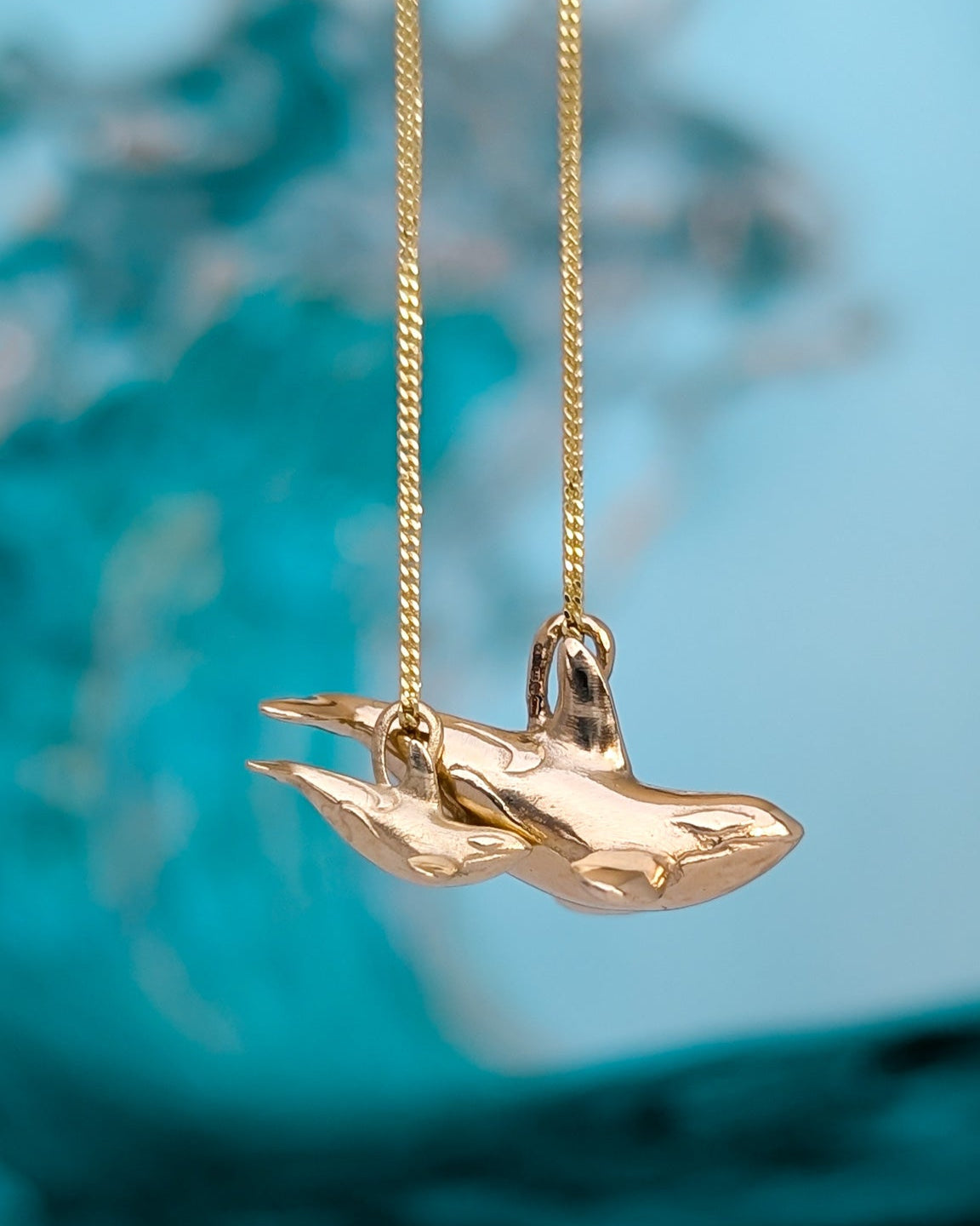 Mum and baby miniature orca whale pendants in 9ct gold