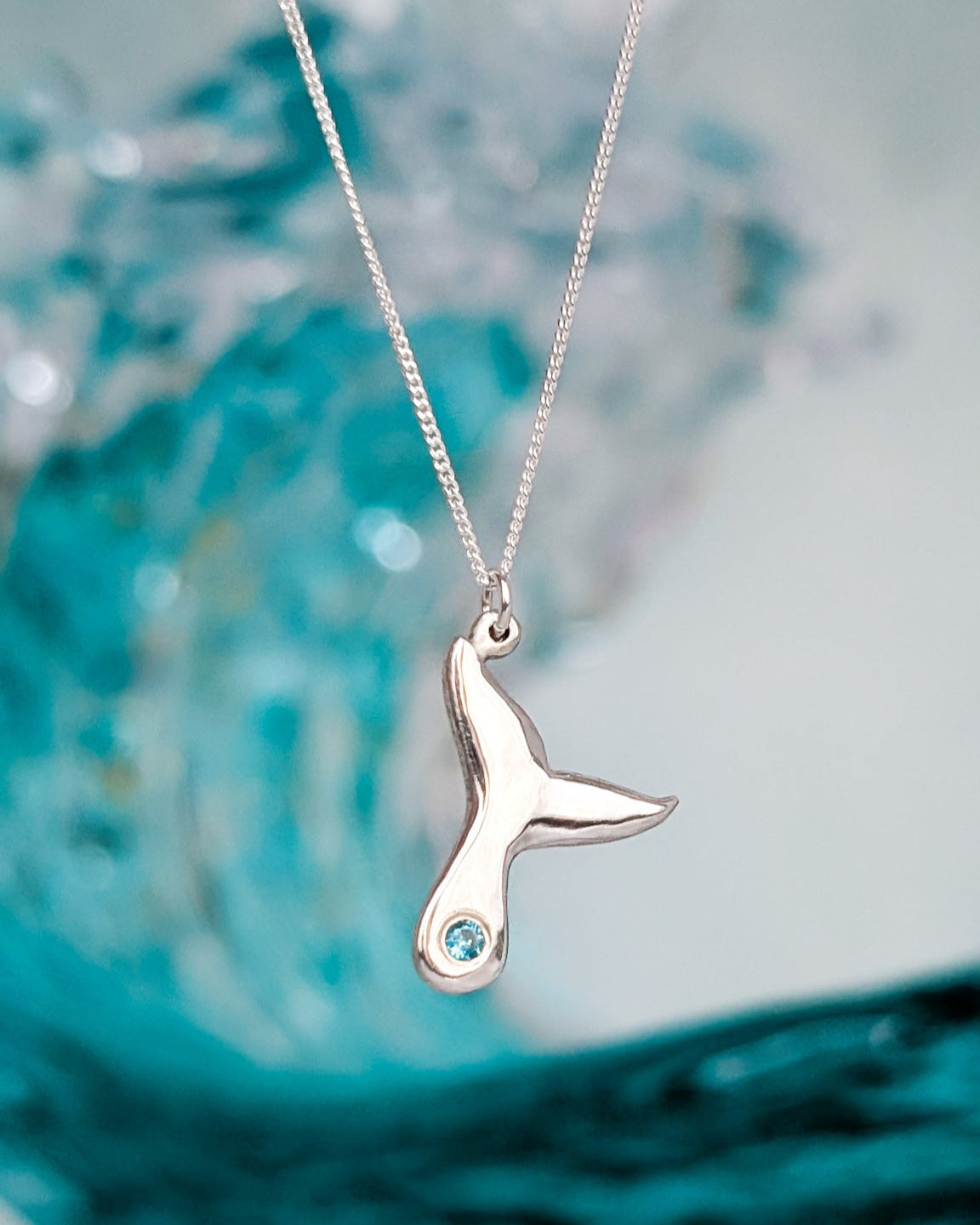 Sterling Silver humpback whale tail necklace with ocean blue stone