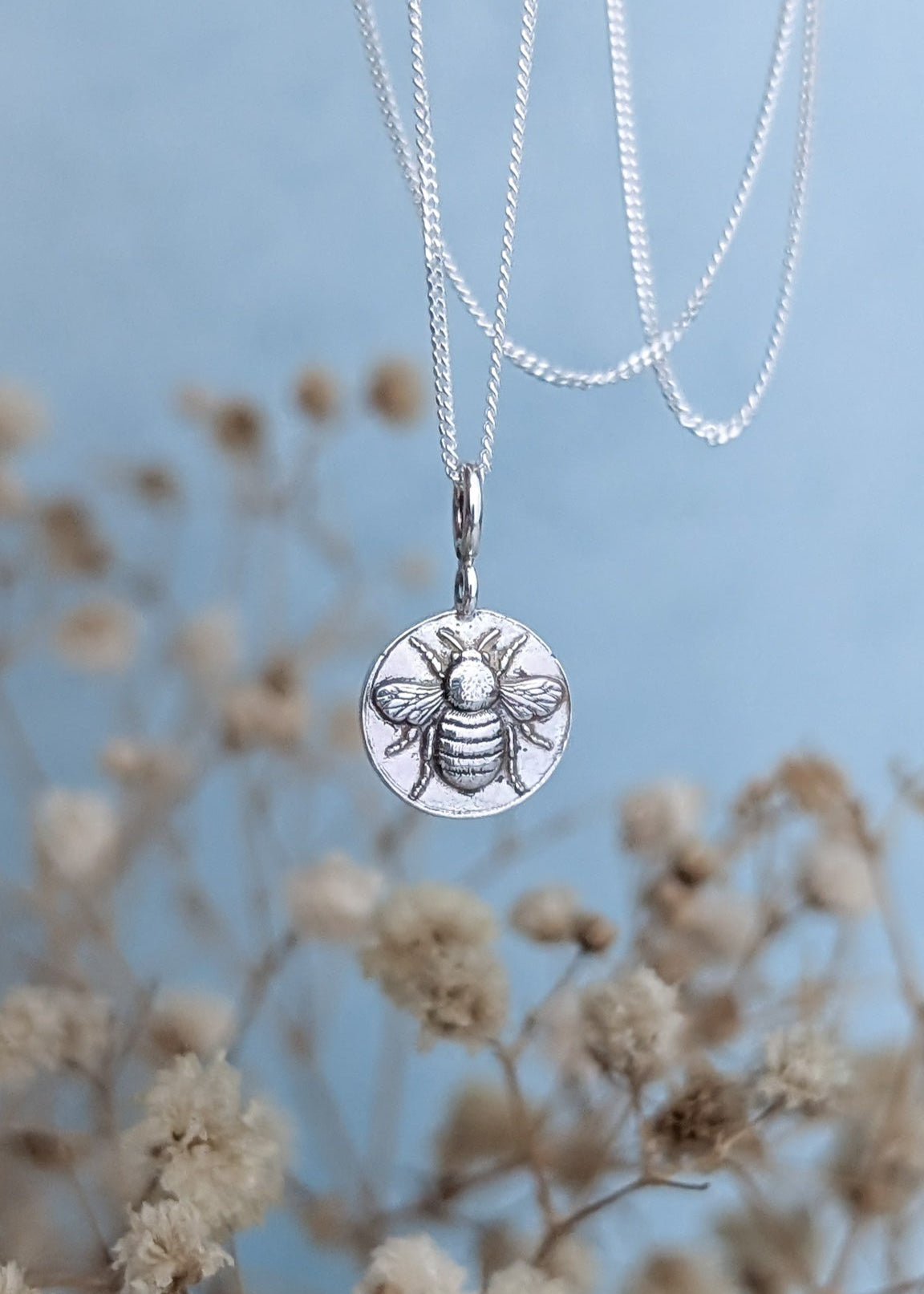 Silver bumblebee coin style necklace