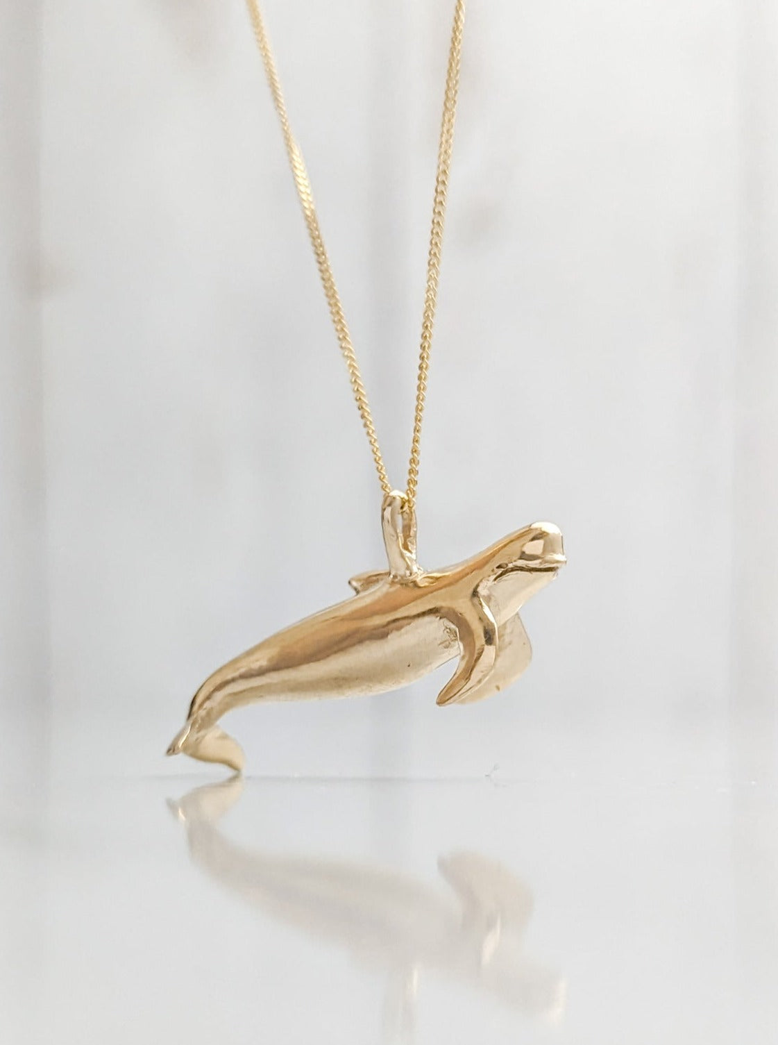 Solid gold pilot whale pendant