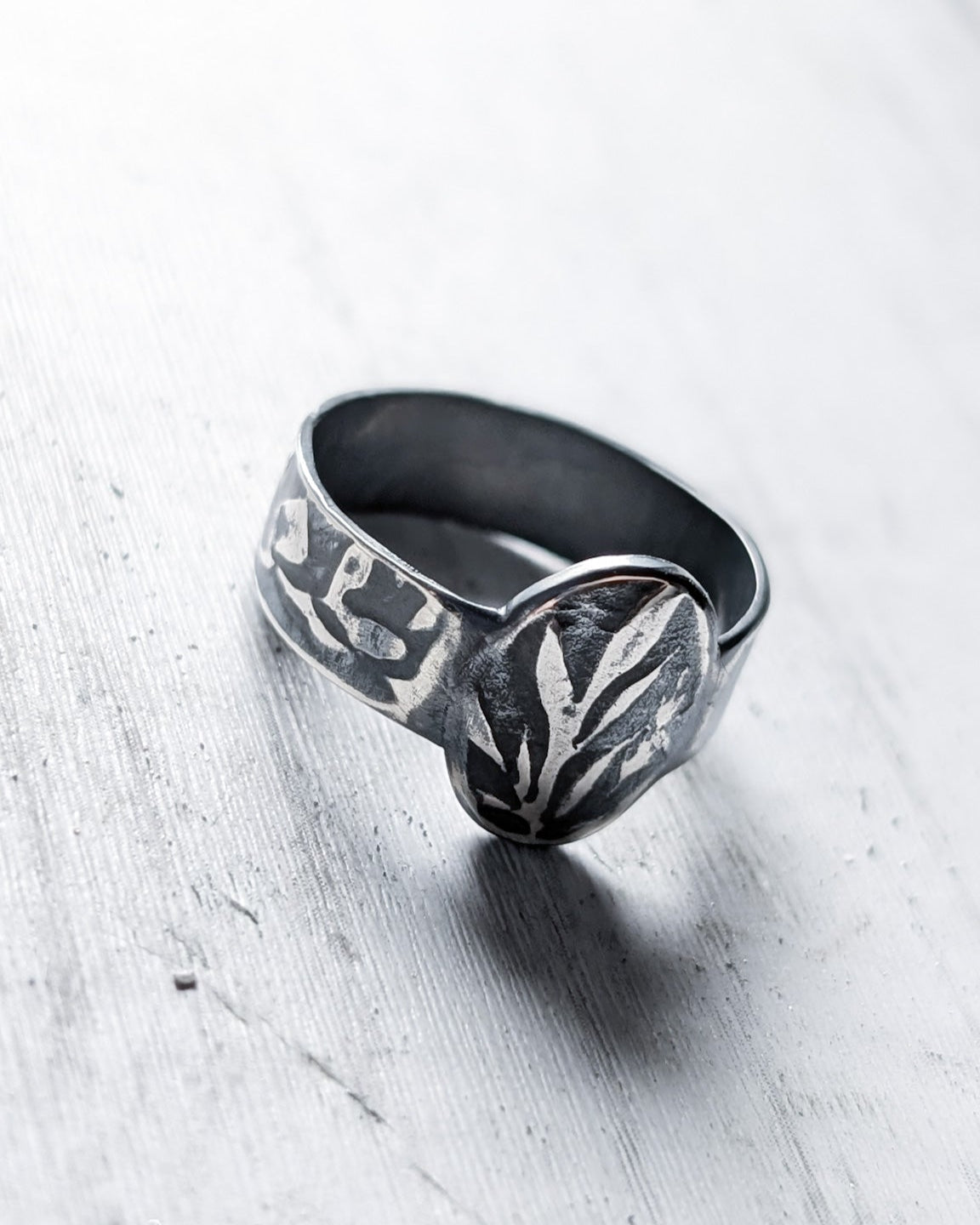 Grassy and leafy texture impressions on a silver signet ring