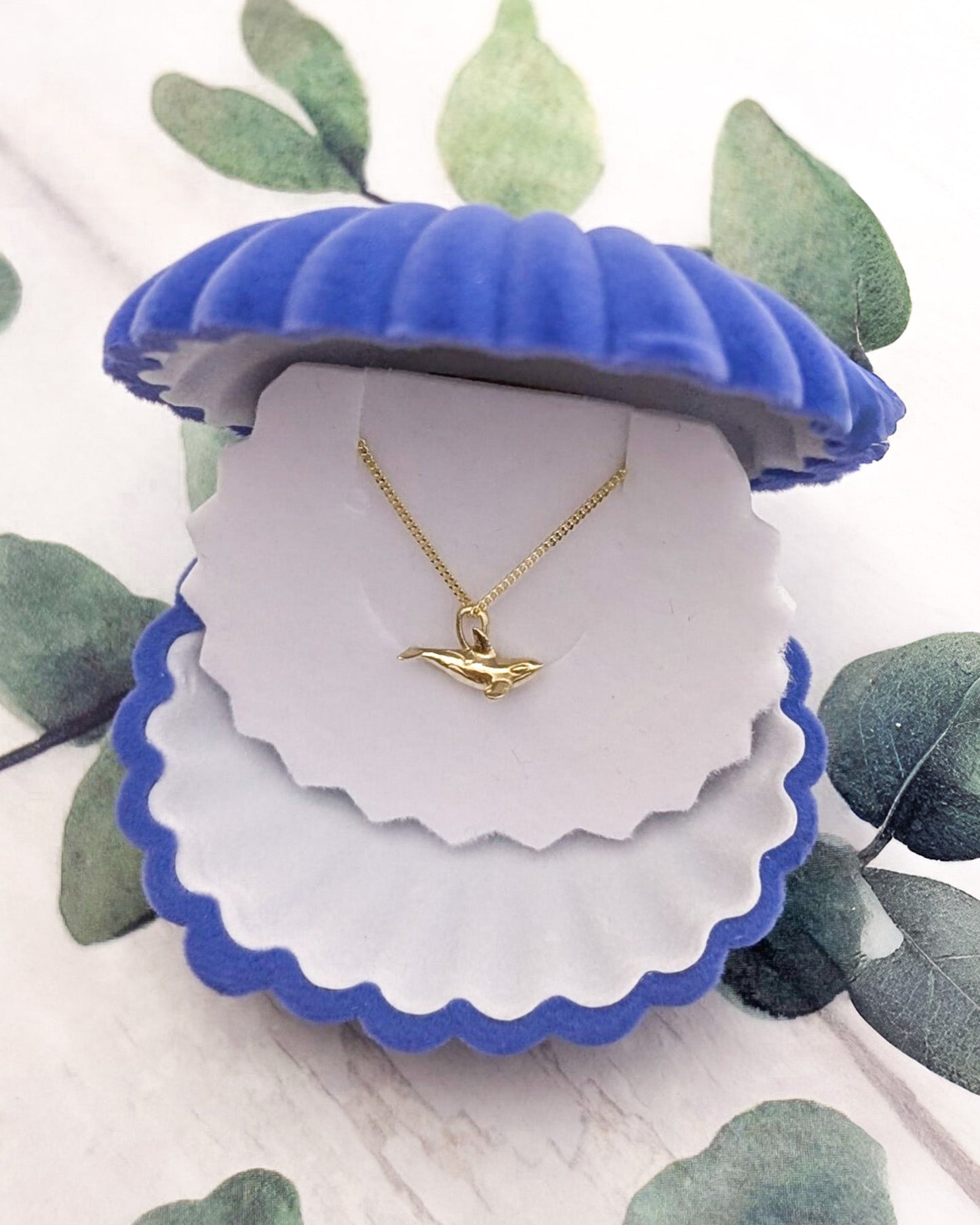 Tiny 1cm orca whale charm in a complimentary blue shell gift box