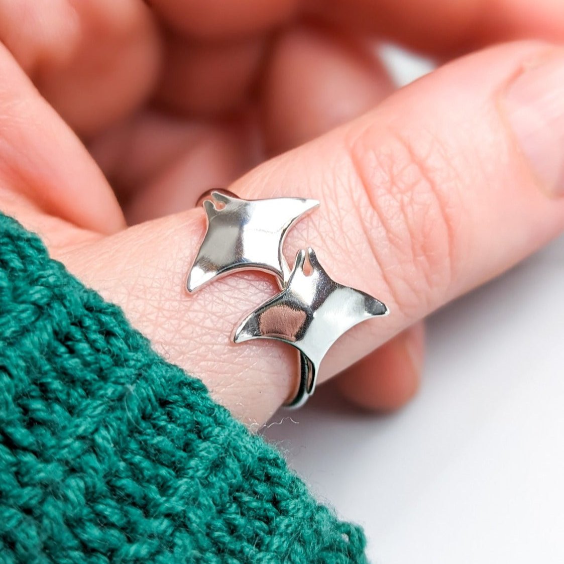 Silver manta ray ring on hand model