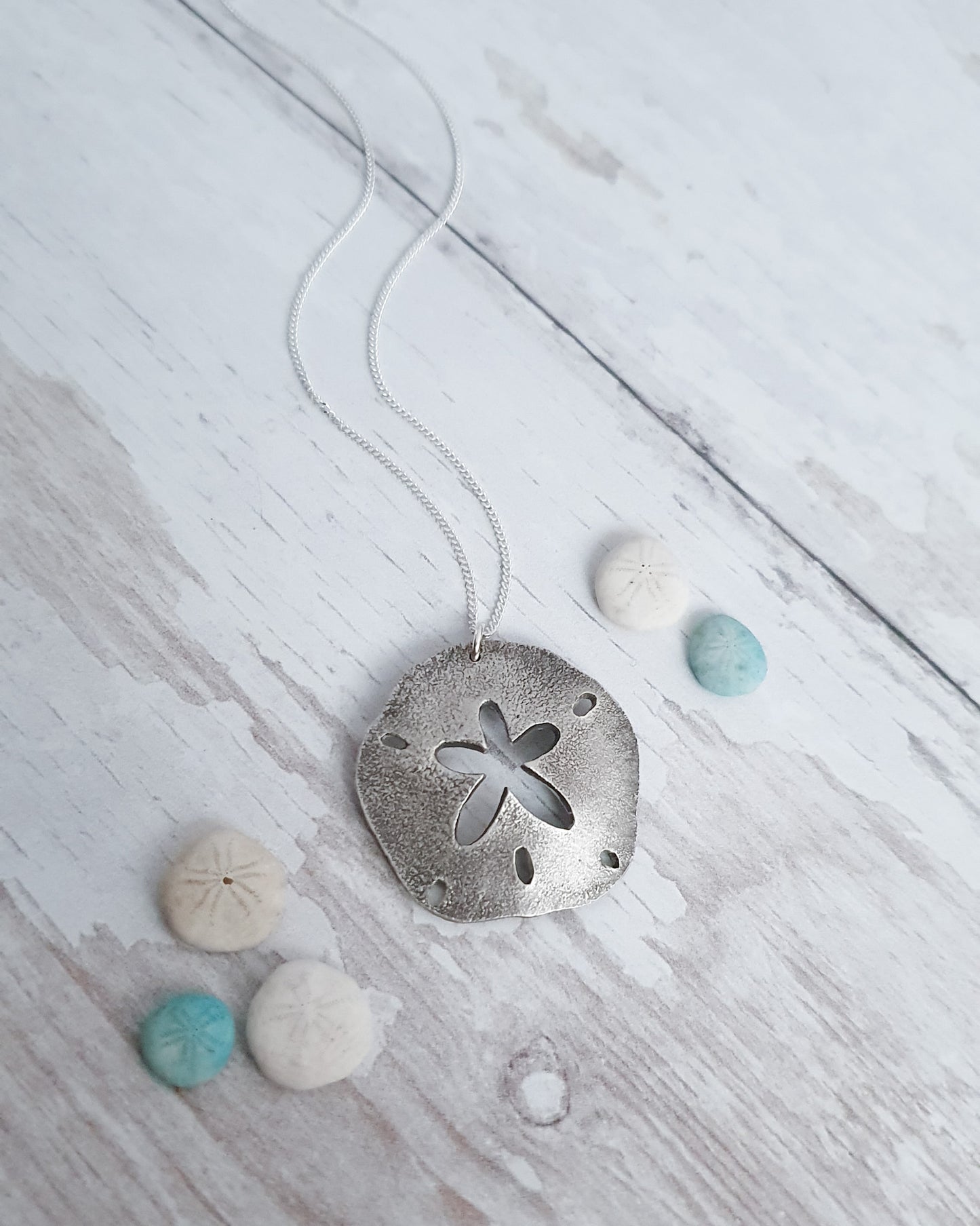 Silver sand dollar pendant