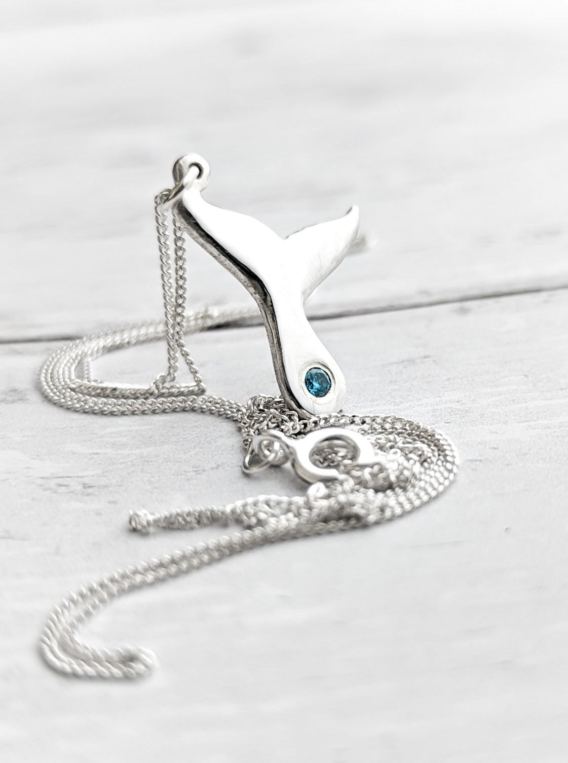 Sterling Silver whale tail necklace with blue stone