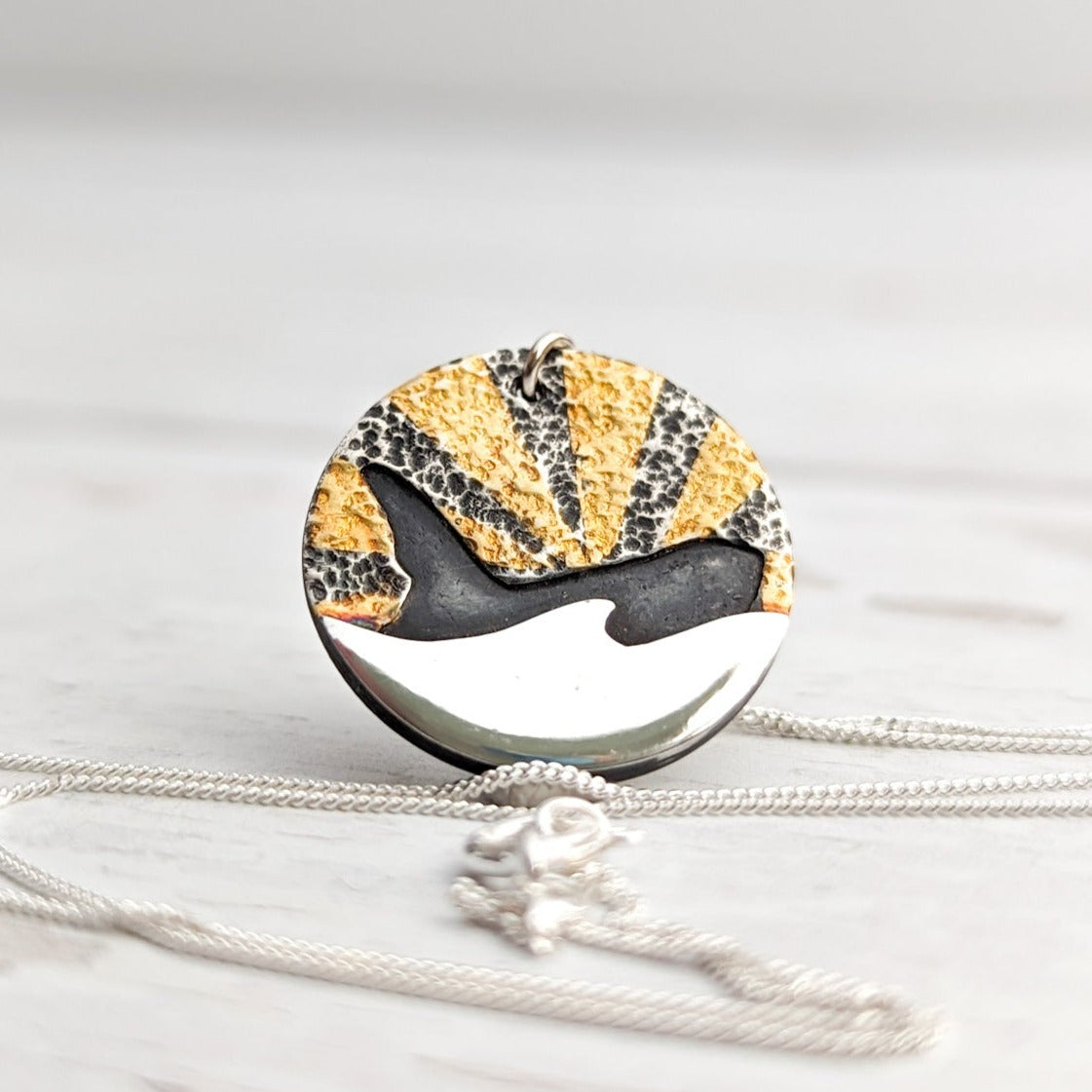 Stunning orca coin pendant with 24 carat gold detail