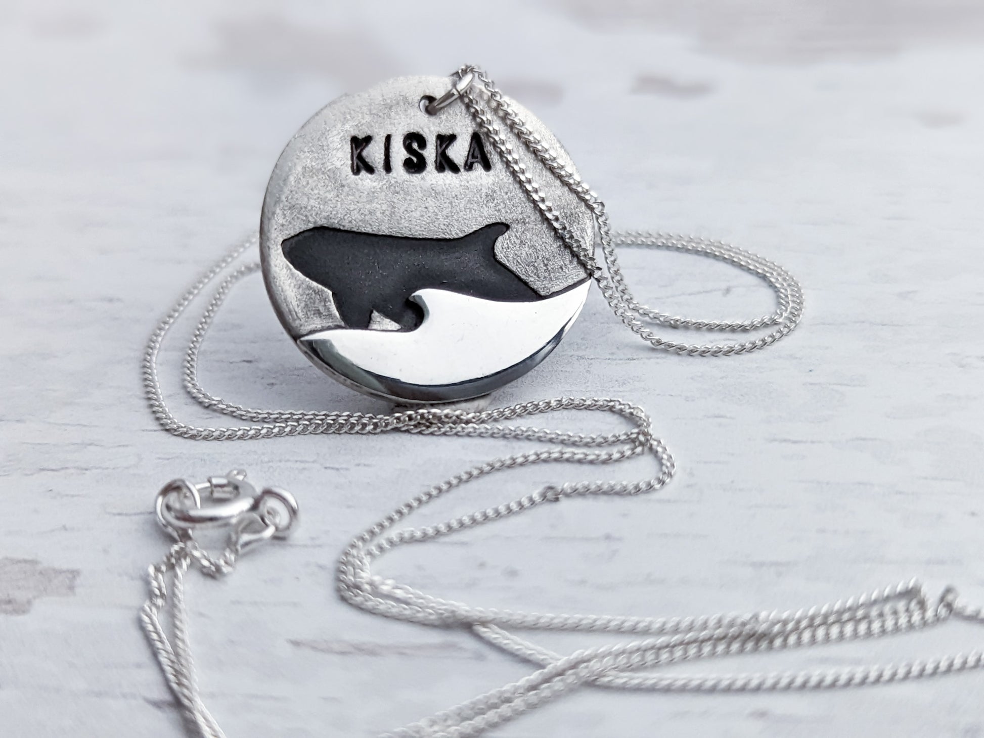 Orca silhouette pendant with ocean wave detail