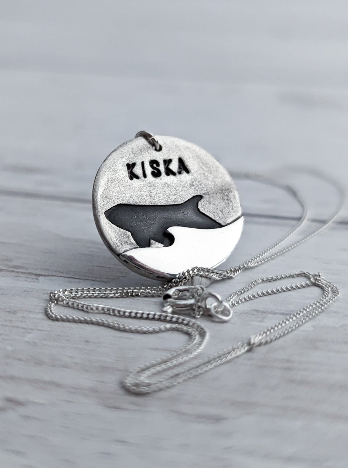 Silver orca coin pendant