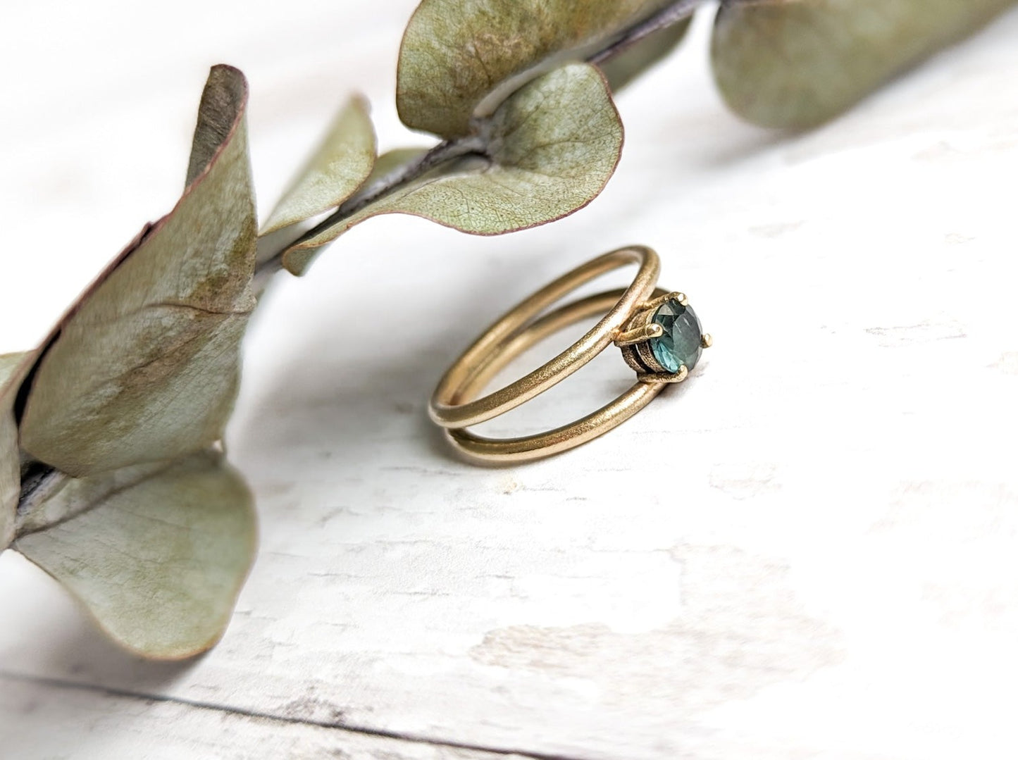 Frosted gold double band ring with teal sapphire