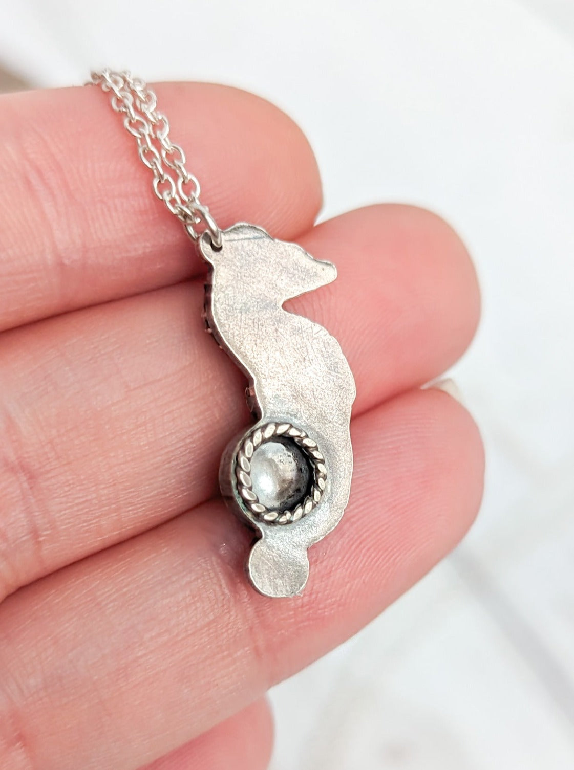 Reverse detail on silver seahorse necklace