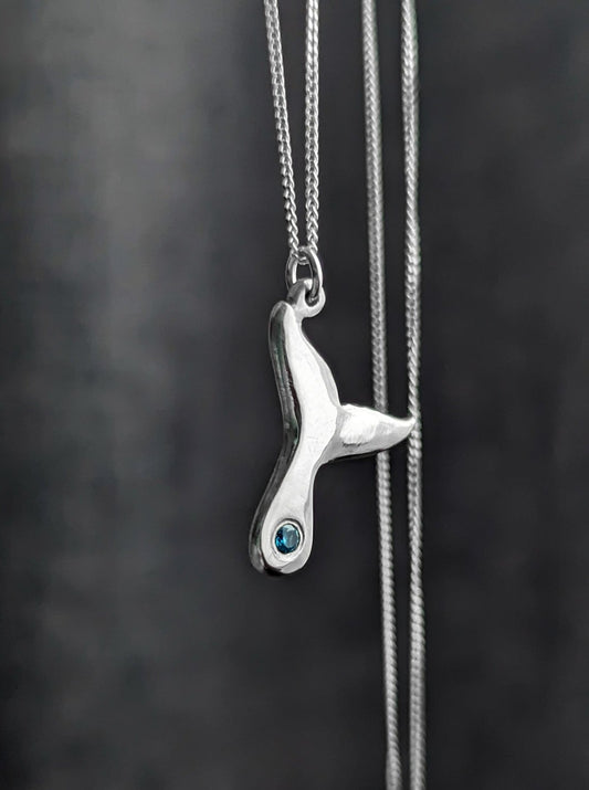Sterling Silver whale tail necklace with flush set blue stone
