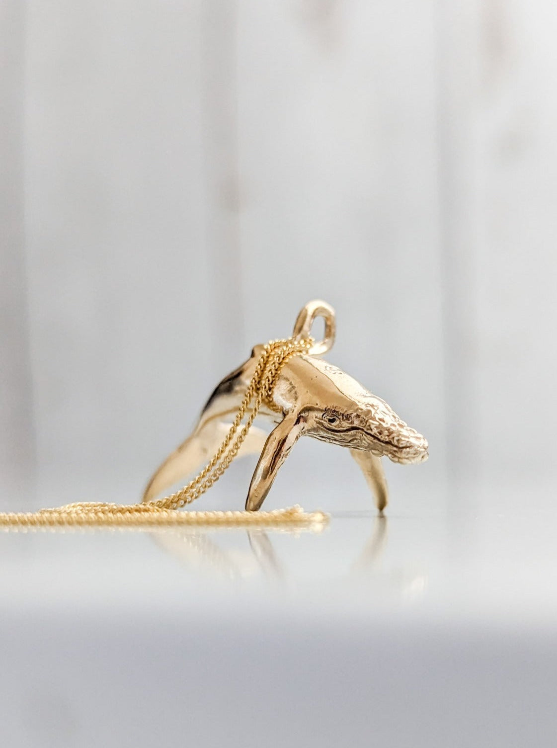 Solid gold petite humpback whale charm pendant