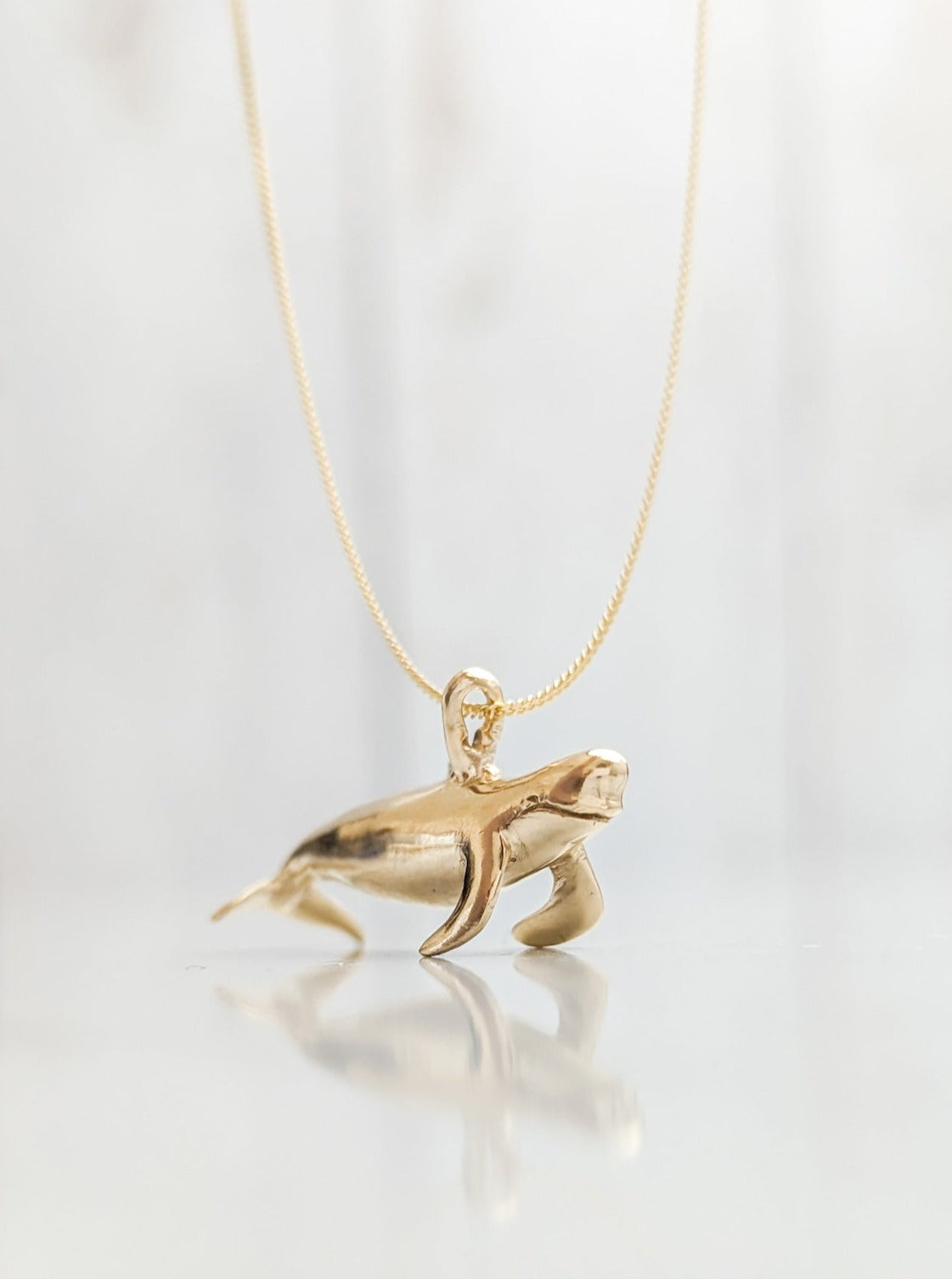 Solid gold pilot whale necklace