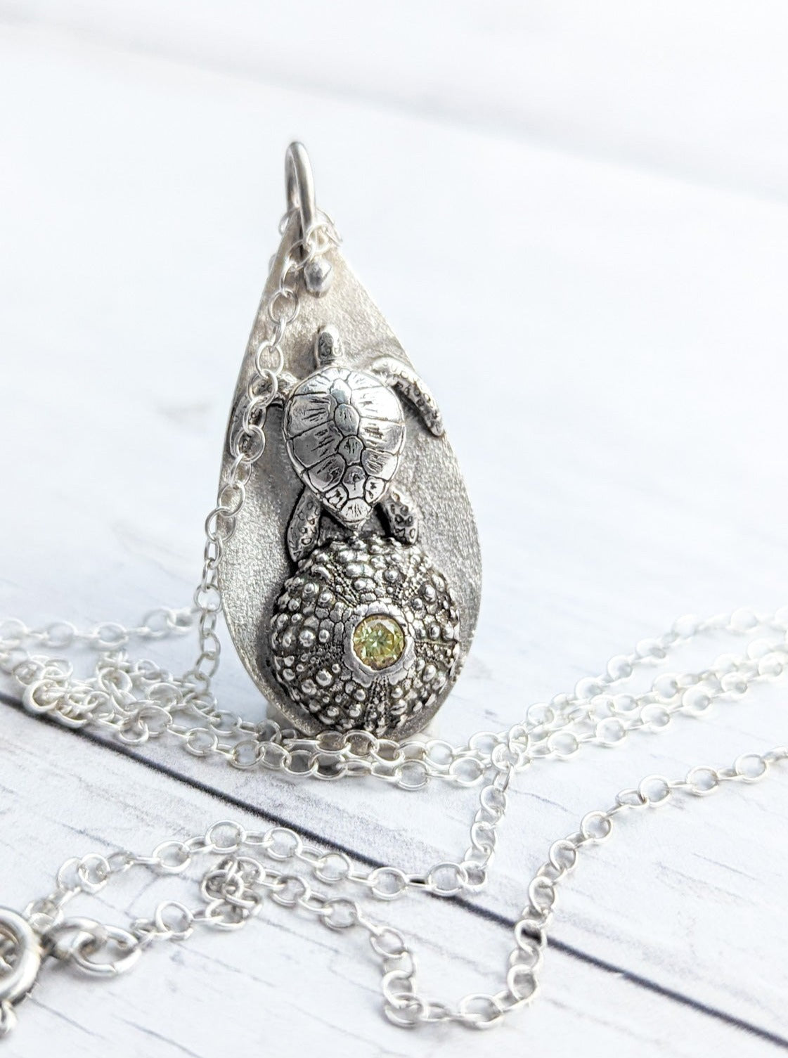 Solid silver sea turtle pendant with sea urchin