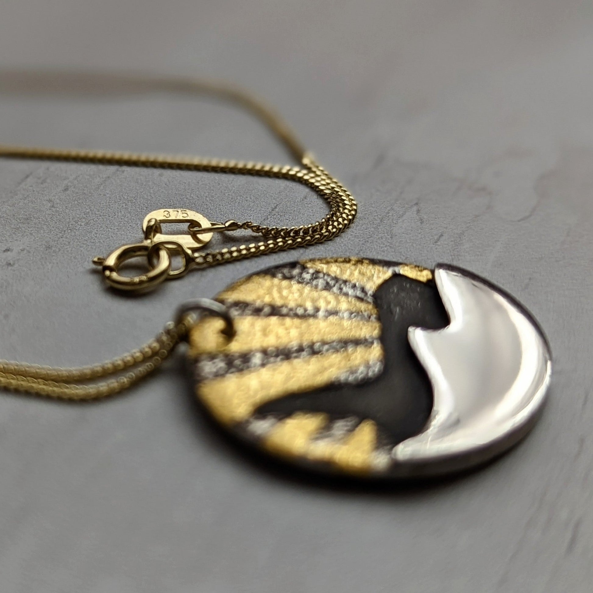 Gold orca necklace on gold chain