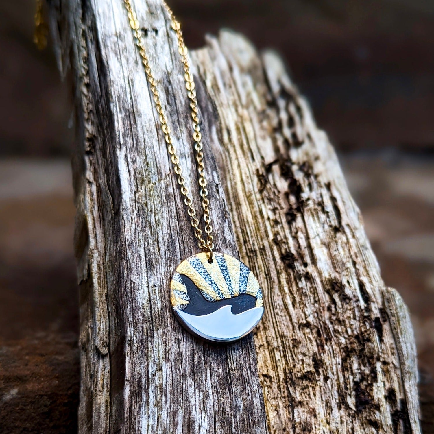 Gold and silver orca whale pendant