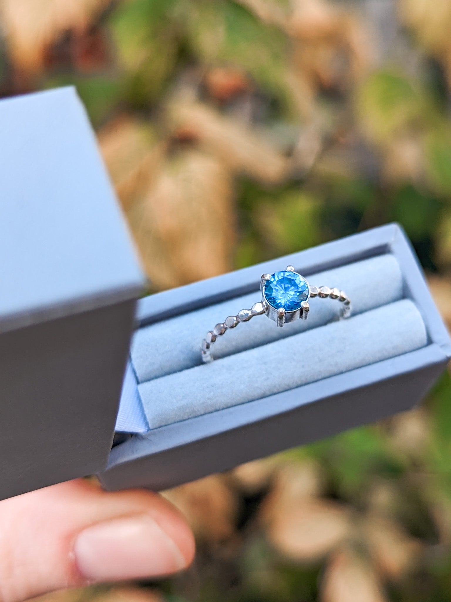 vibrant blue solitaire ring