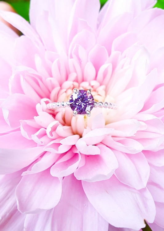 Sparkling purple solitaire ring