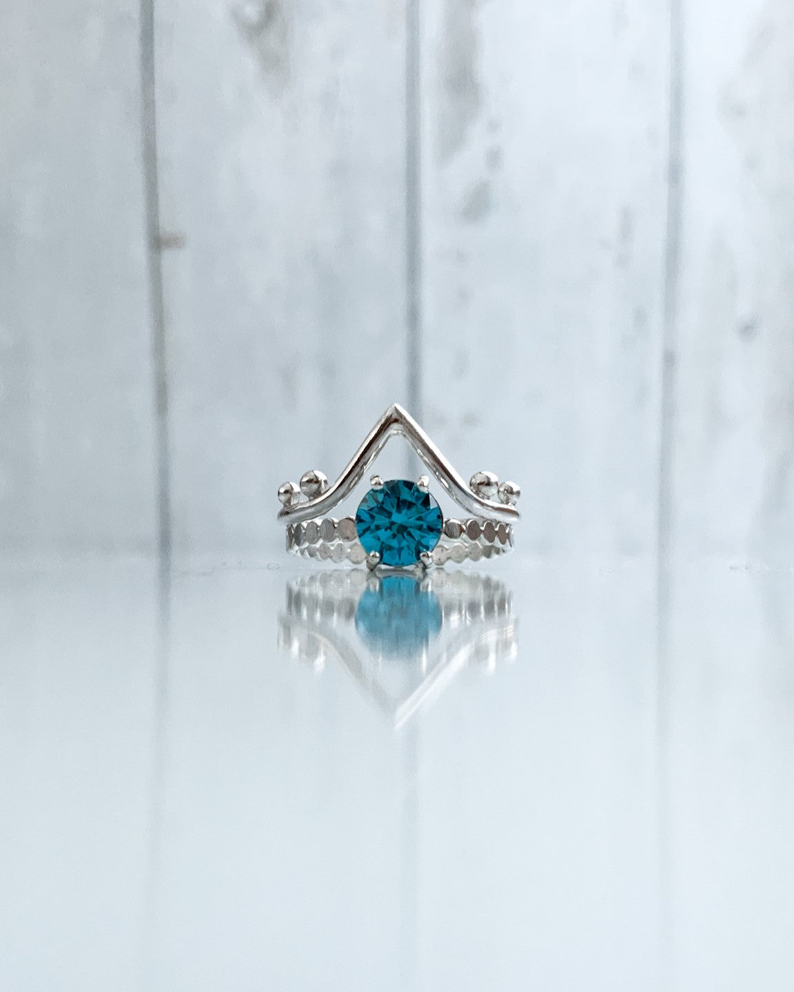 Ocean blue solitaire engagement ring with wishbone wedding band stacker