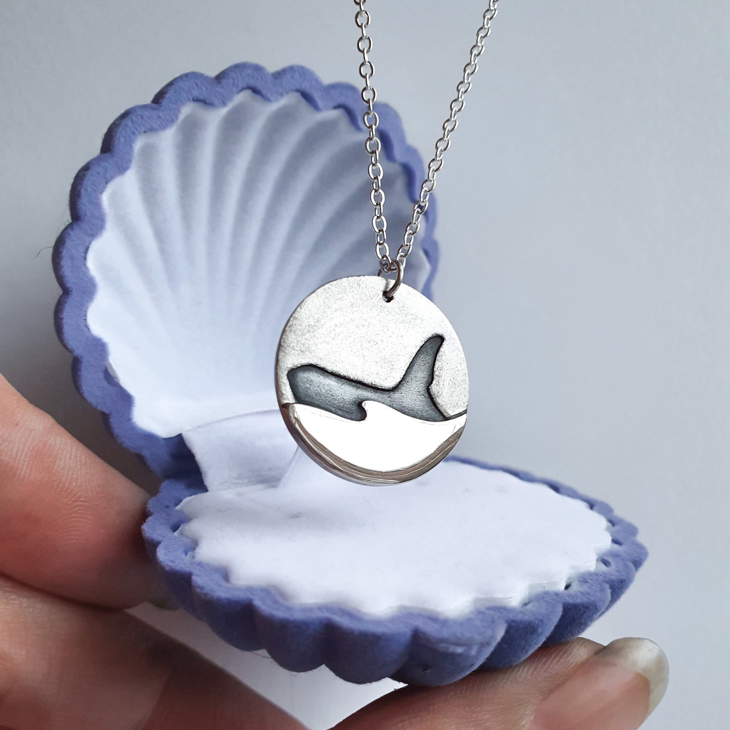 Silver orca pendant in a blue shell gift box