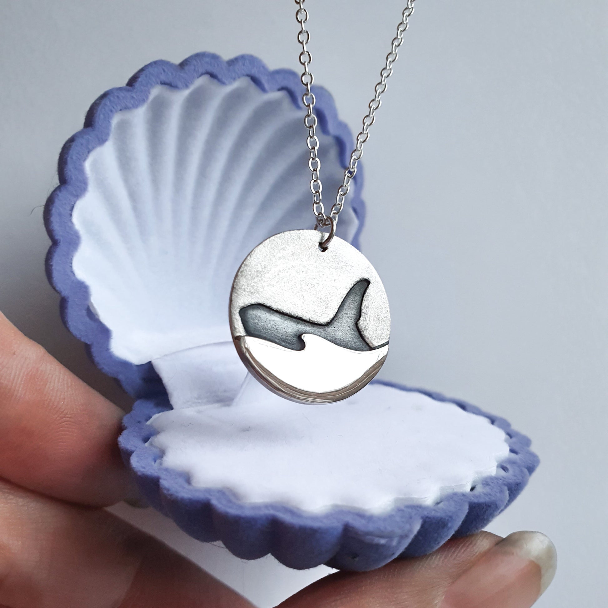 Silver orca pendant in a blue shell gift box