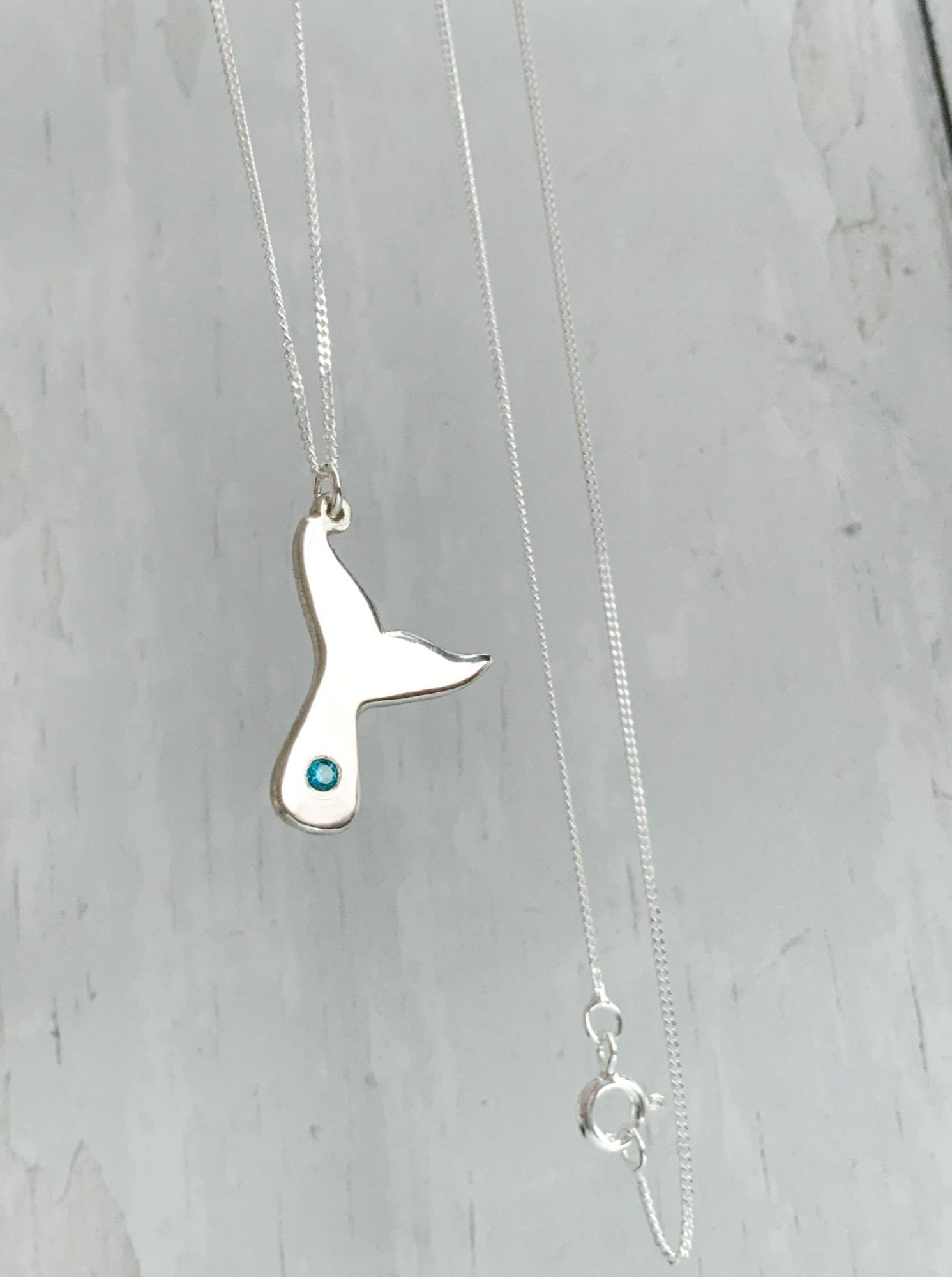 Solid silver whale tail necklace with flush set stone
