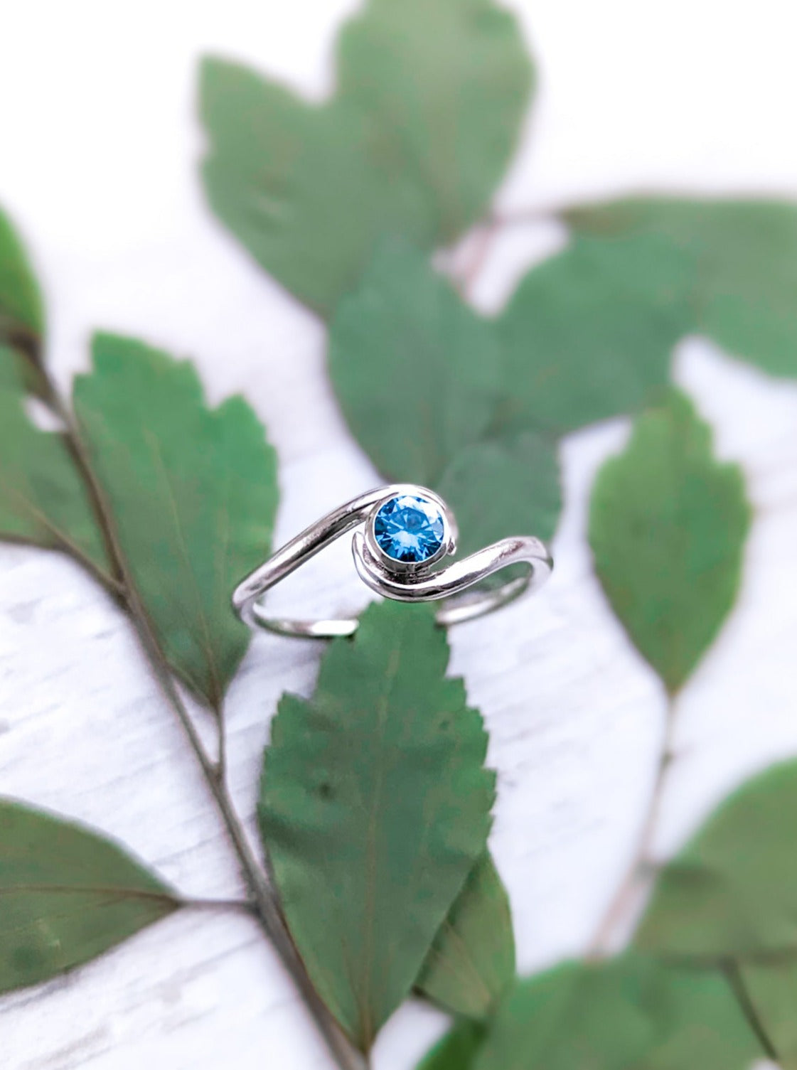 Vibrant blue solitaire engagement ring